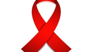 Red ribbon, the AIDS symbol, on a white background