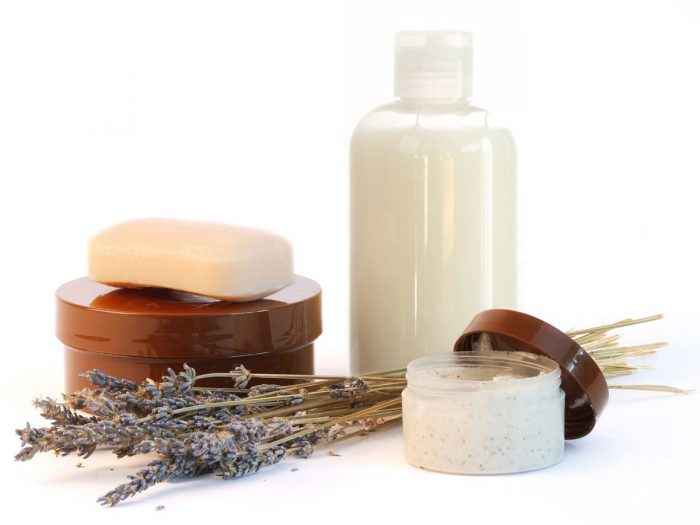 A soap, shampoo, and cream neatly sitting next to each other against a white background