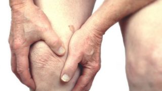 Closeup of a person holding his/her knee