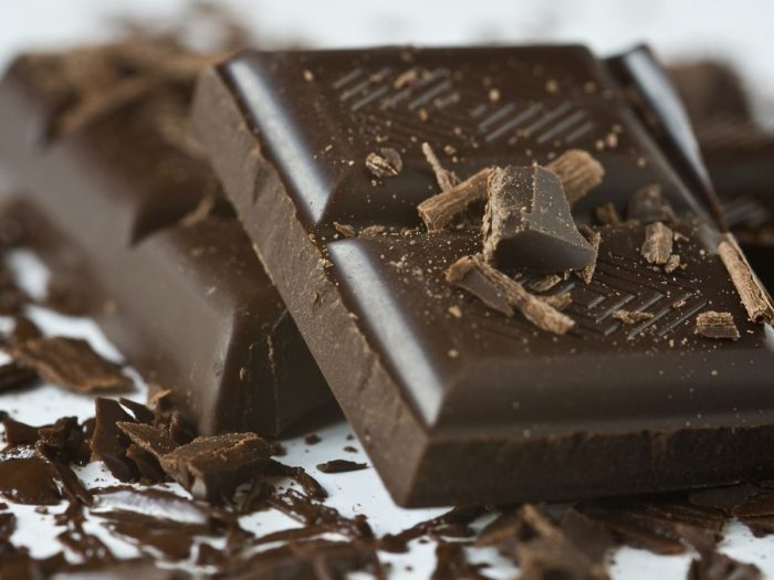A bar of dark chocolate with chocolate bits