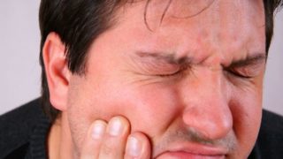 A man suffering from toothache or pain in the mouth