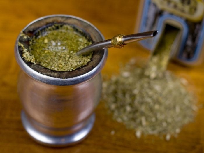 Yerba mate tea mixed in water kept atop a wooden table