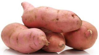 A closeup view of sweet potatoes on a white background