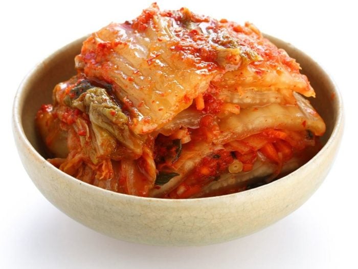 A bowl of kimchi on a white background