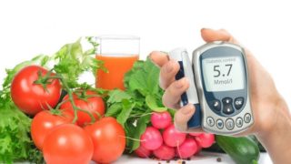 Daikon, tomatoes, cucumber, carrots and vegetables that can help manage diabetes near a glucose meter