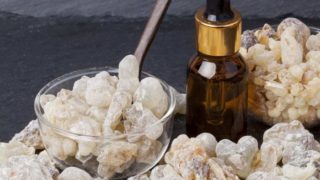 A bottle of frankincense oil with frankincense resin crystals