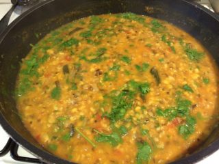 Mixed tadka dal Organic mixed tadka dal in a saucepan, garnished with coriander leaves