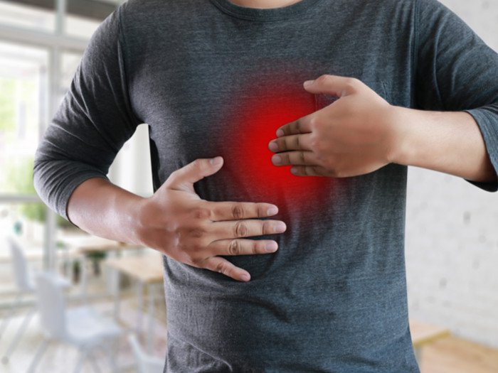 A man suffering from heartburn - symptoms of acid reflux