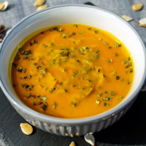 African peanut soup in a medium-sized white bowl kept atop a table