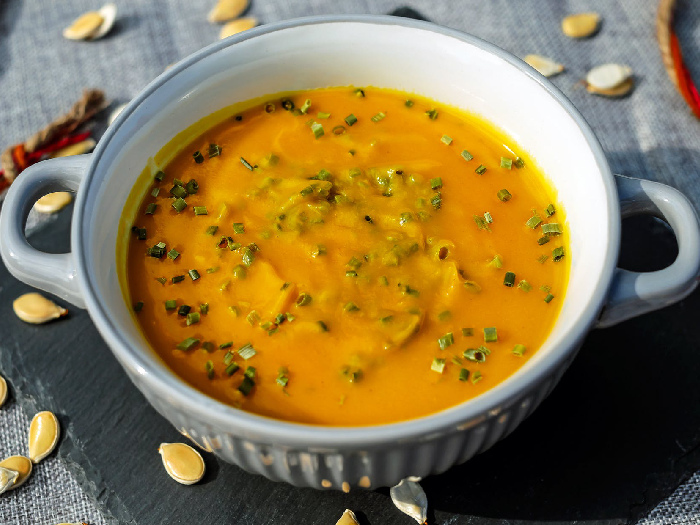 African peanut soup in a medium-sized white bowl kept atop a table