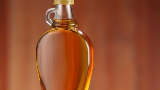 A bottle of honey, maple syrup, or agave nectar