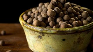 A close-up shot of allspice in a bowl