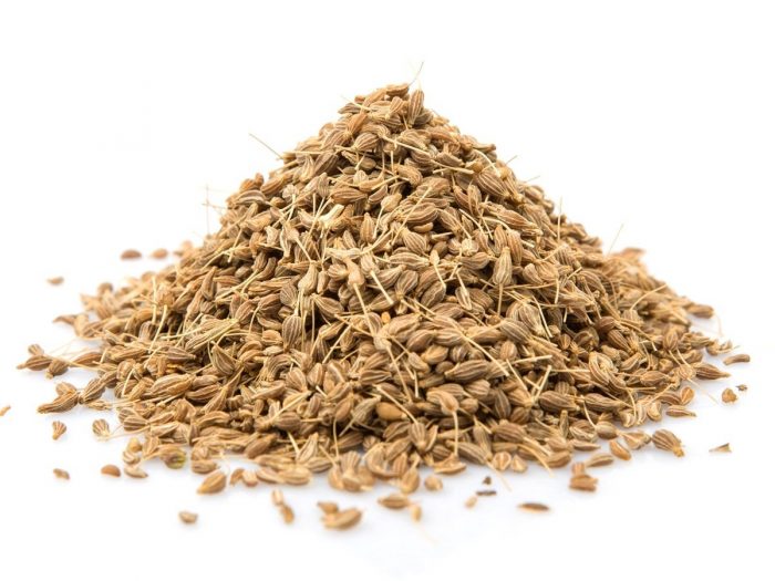 A close-up shot of anise seeds against a white background