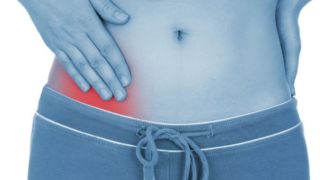 A young woman with severe abdominal pain suffering from appendicitis