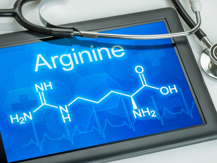 A tablet showing the chemical equation for arginine with a stethoscope next to it