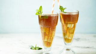 Homemade iced tea with mint and lemon or Arnold Palmer drink