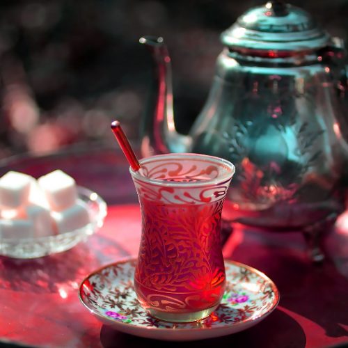 A teapot of Azerbaijani Turkish tea, traditional glass, and sugar on a tray