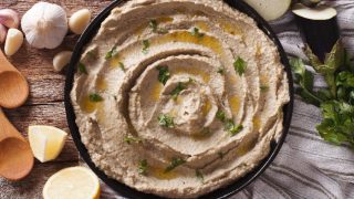 Arabic food baba ghanoush close-up on the plate and ingredients on the table