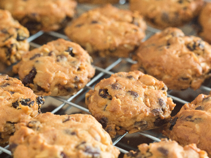 Freshly baked peanut butter cookies with chocolate chips on a rack