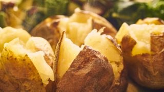 A close up shot of hot buttered jacket baked potatoes
