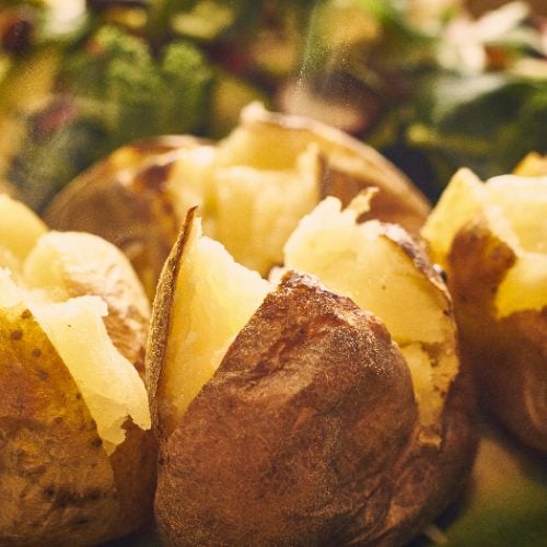 A close up shot of hot buttered jacket baked potatoes