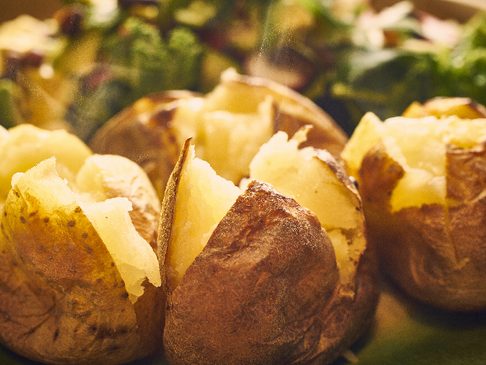 A close up shot of hot buttered jacket baked potatoes