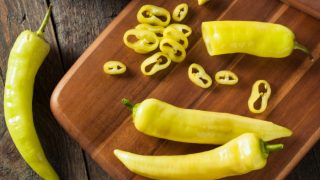 Banana peppers on a chopping board