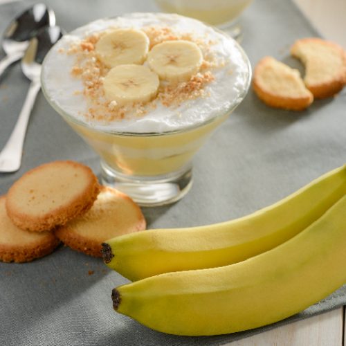 Bananas, cookies and cream pudding on a gray tablecltoh. Result of simple recipe, yummy food and fresh ingredients