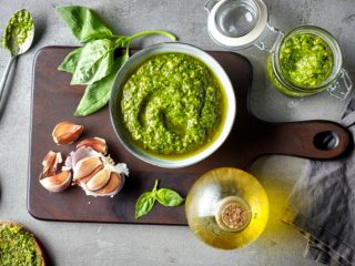 basilpesto Basil pesto sauce in a bowl next to other ingredients