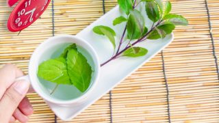 Basil tea leaves on a white plate