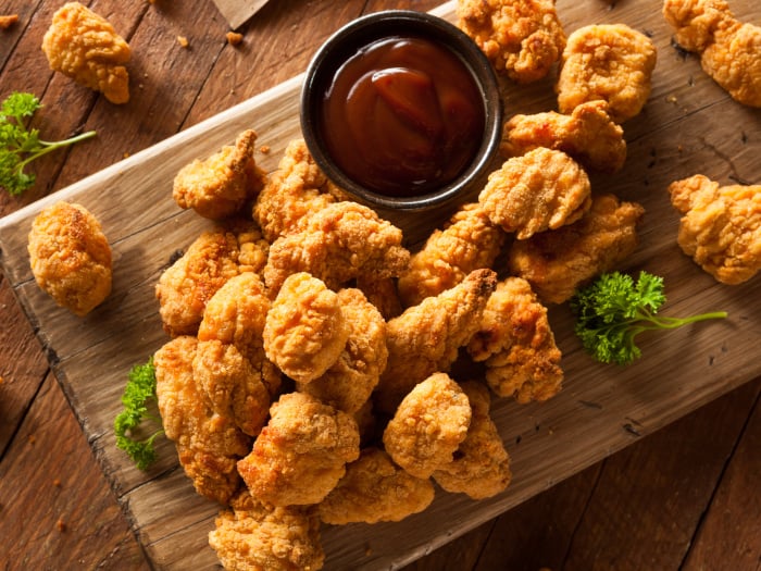 Homemade crispy popcorn chicken with barbecue sauce