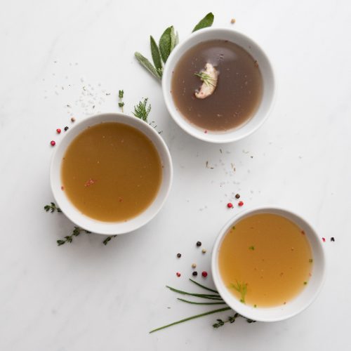 Assortment of beef tea broth in small bowls