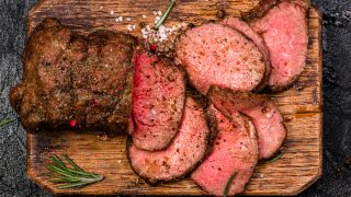 Roast beef on cutting board with salt and pepper