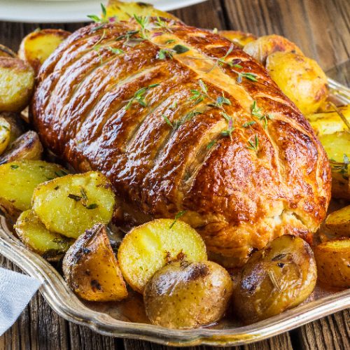 Beef Wellington on a rustic wooden table