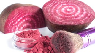Homemade beet powder cosmetics kept beside beetroots