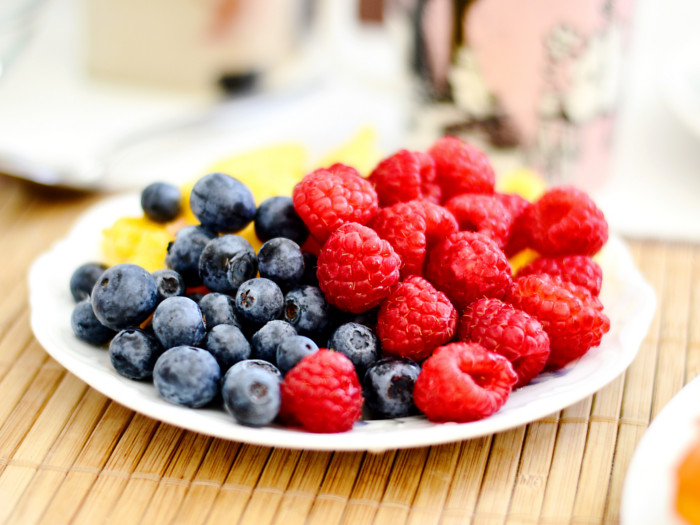 Blueberries and crimson berries in a plate
