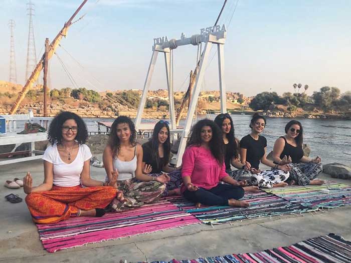 A picture of Bhavini Kalan taking a yoga class at the bank of a river