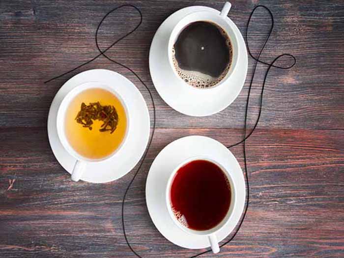 Different varieties of tea in white teacups
