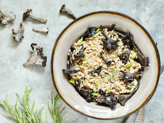 Risotto in a bowl made with black trumpets and chanterelles