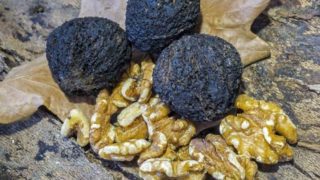 Black walnuts on a wooden table