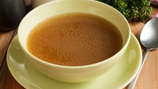 A close-up view of bone broth in a bowl