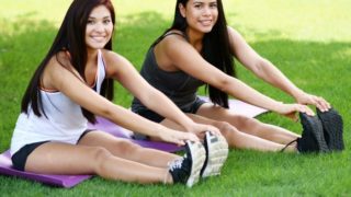 Two young girls working out in a park