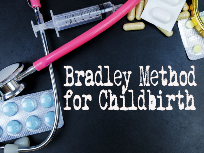 Bradley method for childbirth written on a grey surface with medical equipments beside it