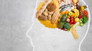 Sketch of a human brain with a collage of vegetables in place of the brain.