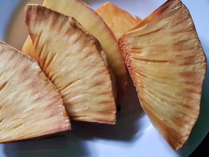Roasted breadfruit on a blue dish
