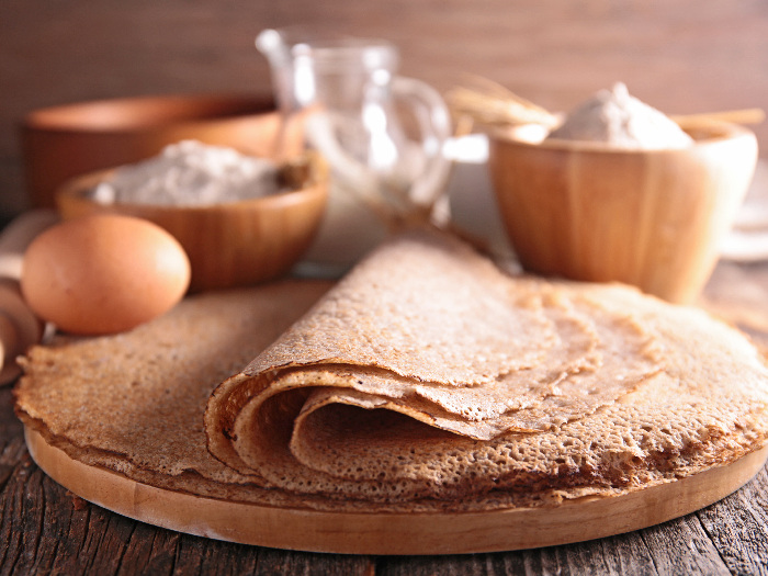 Buckwheat crepes with ingredients in the background