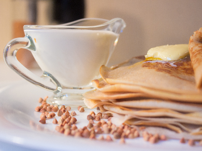 Buckwheat crepes with ingredients in the background