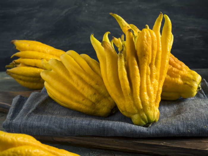 Buddha hand fruits placed on a gray cloth