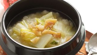 Cabbage soup in a black bowl