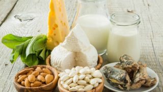 A table full of calcium-rich foods such as milk, cheese, and almonds